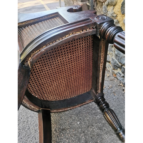 160 - A William IV mahogany and canework library bergere chair, in the Gillows style with curved rail and ... 