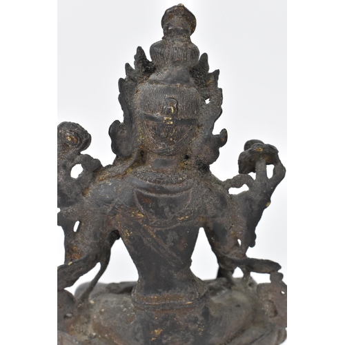 218 - A 19th century Sino-Tibetan cast bronze model of green Tara Buddha, 19.5 cm high