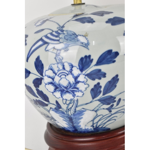 224 - A pair of Chinese Qing dynasty celadon porcelain lamps, 19th century, with blue and white peony bloo... 