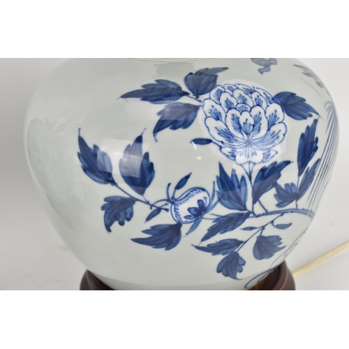 224 - A pair of Chinese Qing dynasty celadon porcelain lamps, 19th century, with blue and white peony bloo... 