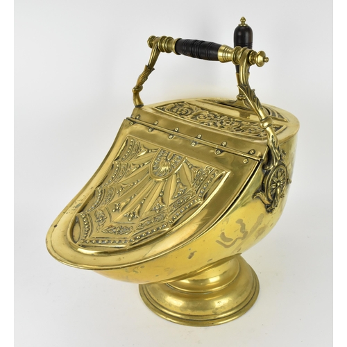 225 - A 19th century Regency period brass coal scuttle, with shovel, the top with embossed acanthus leaf s... 