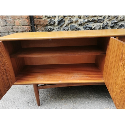 52 - A mid-century G-Plan Brasilia teak sideboard, fitted with four central drawers, the top one with cut... 