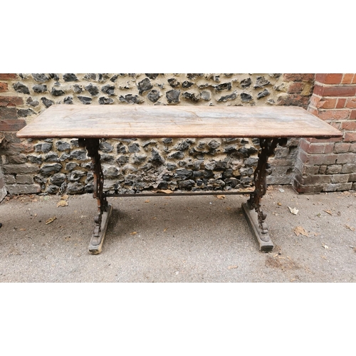 164 - A Victorian cast iron rectangular pub table with a mahogany top, over brown painted pierced, scrolle... 