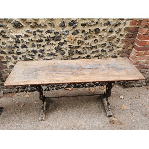 164 - A Victorian cast iron rectangular pub table with a mahogany top, over brown painted pierced, scrolle... 