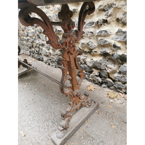 164 - A Victorian cast iron rectangular pub table with a mahogany top, over brown painted pierced, scrolle... 