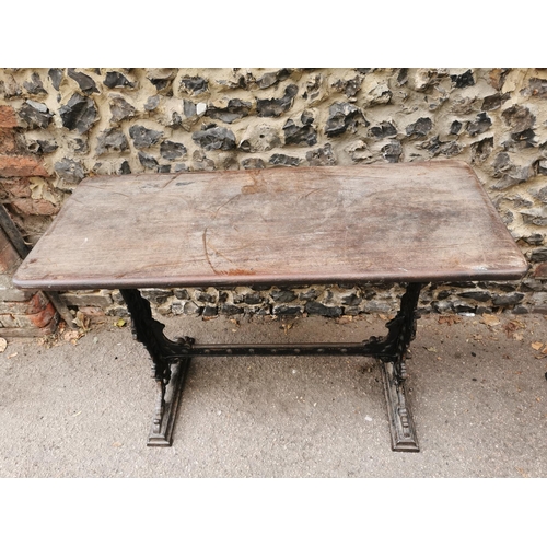 165 - A Victorian cast iron rectangular pub table, with a mahogany top, over a black painted pedestal base... 