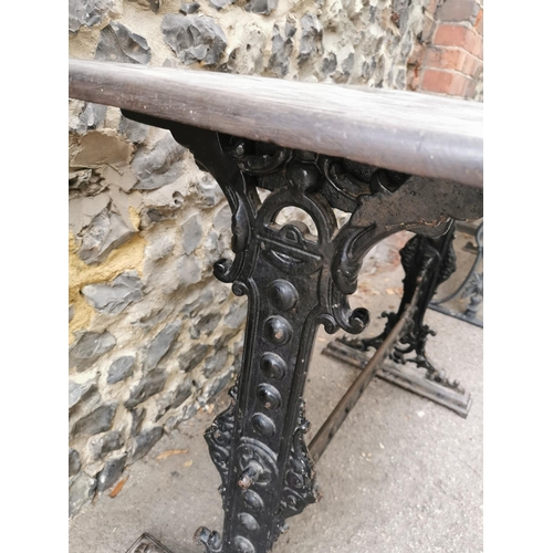 165 - A Victorian cast iron rectangular pub table, with a mahogany top, over a black painted pedestal base... 