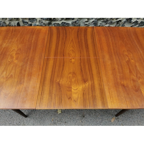 55 - A mid 20th century McIntosh teak dining suite, comprising a rectangular extending table with conceal... 