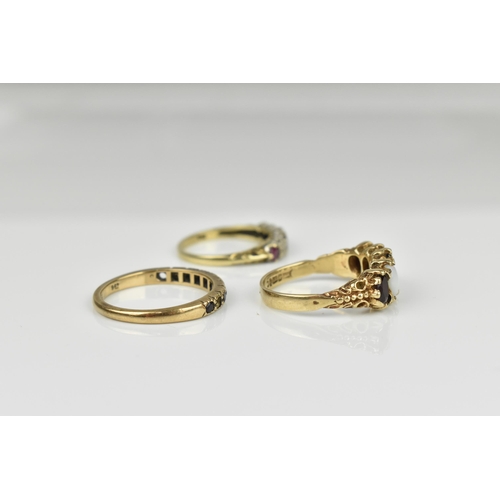 127 - A small group of dress rings, to include a 9ct yellow gold, garnet and white opal five stone ring, a... 