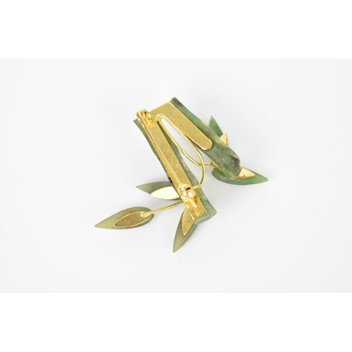 128 - A naturalistic carved nephrite brooch modelled as bamboo leaves, with gold-plated backing and fasten... 