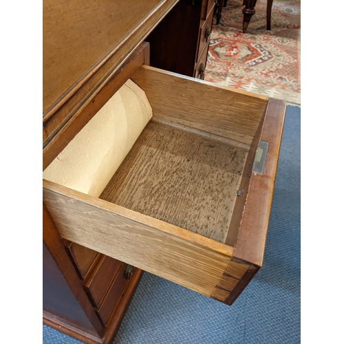 220 - An early 20th century mahogany bookcase having a dental moulded cornice above twin glazed doors, rol... 