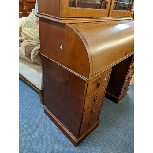 220 - An early 20th century mahogany bookcase having a dental moulded cornice above twin glazed doors, rol... 