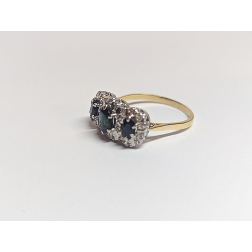 1 - A gold and white metal ring set with three sapphires 0.36 to 0.65ct, each surrounded by diamonds Loc... 