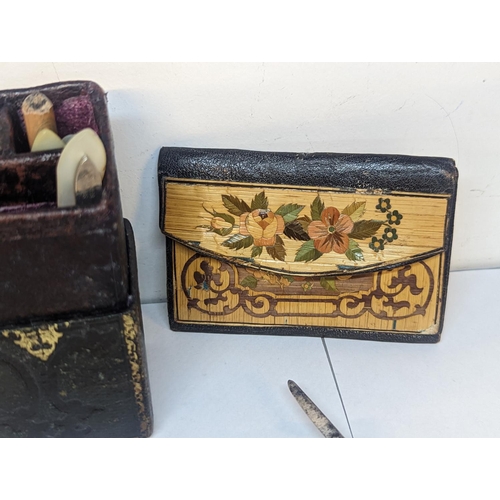 122 - A miniature  ladies companion set in the form of a book, a POW straw and leather purse and a mother ... 