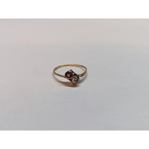 143 - A yellow metal, testing as gold, ring inset with a diamond and ruby
Location: RING