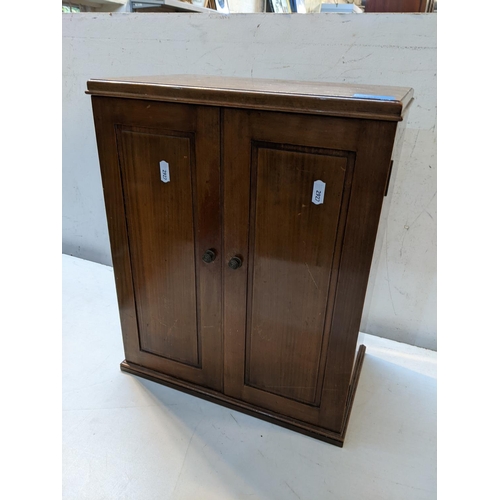 180 - A 20th century mahogany smokers cabinet having a fitted interior with two cupboard doors, 45h x 37w
... 