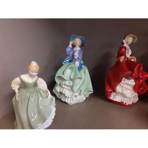 197 - A quantity of bone china figures to include Royal Doulton Top of the Hill HN1834 and an earlier Top ... 