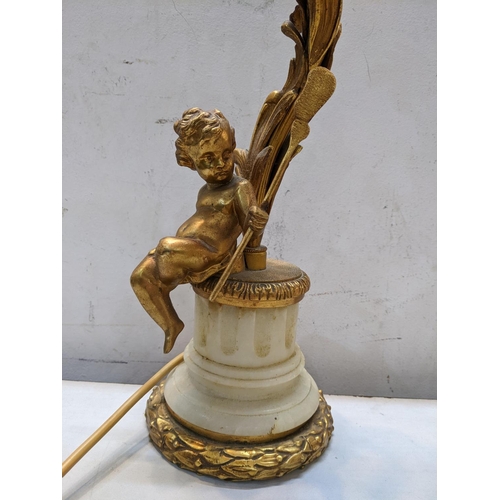 26 - A mid 20th century gilt metal table lamp in the form of a cherub leaning against a floral vine, 42cm... 