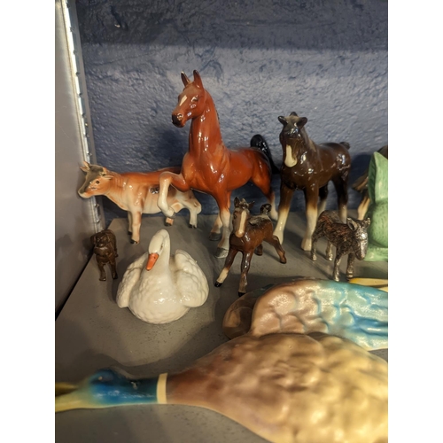 300 - A group of porcelain and other model animals to include Beswick horse and others, cattle, donkey, wa... 