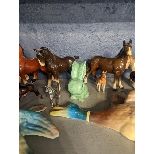 300 - A group of porcelain and other model animals to include Beswick horse and others, cattle, donkey, wa... 