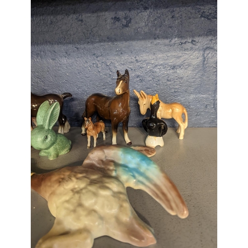 300 - A group of porcelain and other model animals to include Beswick horse and others, cattle, donkey, wa... 