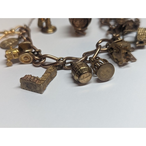 4 - A 9ct gold curb link charm bracelet having eleven various charms to include The Palace of Westminste... 