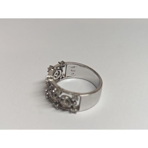 5 - A designer 18ct white gold ring inset with 19 diamonds in a pierced setting 6.4g, along with a Tiffa... 