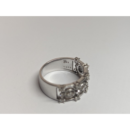 5 - A designer 18ct white gold ring inset with 19 diamonds in a pierced setting 6.4g, along with a Tiffa... 