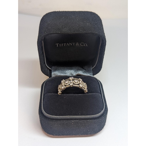 5 - A designer 18ct white gold ring inset with 19 diamonds in a pierced setting 6.4g, along with a Tiffa... 