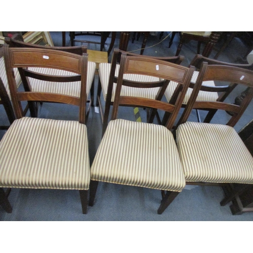 70 - A set of seven Regency mahogany bar back dining chairs, striped upholstered seats, on square taperin... 