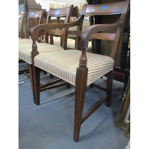 70 - A set of seven Regency mahogany bar back dining chairs, striped upholstered seats, on square taperin... 