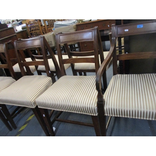 70 - A set of seven Regency mahogany bar back dining chairs, striped upholstered seats, on square taperin... 