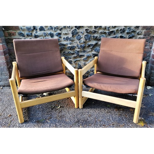 69 - A pair of 1970s beech armchairs, in the Parker Knoll style, the back rest and seat cushion in brown ... 