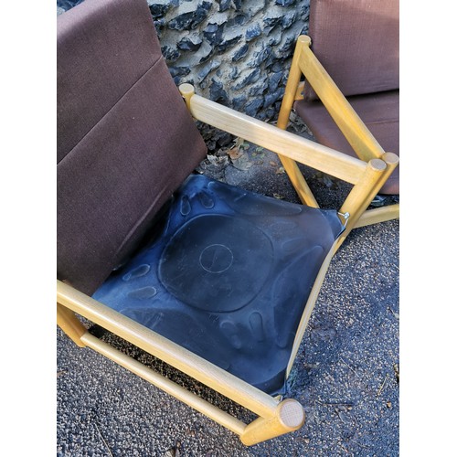 69 - A pair of 1970s beech armchairs, in the Parker Knoll style, the back rest and seat cushion in brown ... 