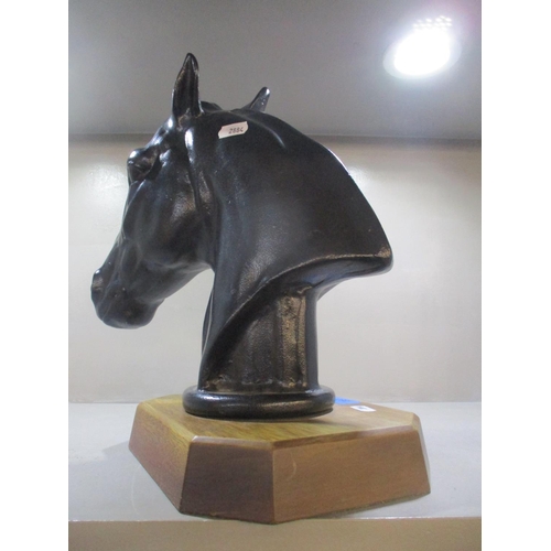 287 - A back finished metal sculpture of a horses head mounted on a wooden base, 28cm high, without base
L... 