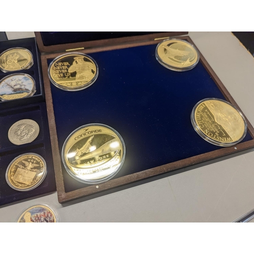 369 - A group of British commemorative coins to include gold plated Concorde and Winston Churchill example... 