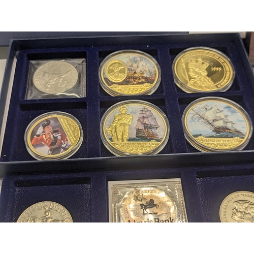 369 - A group of British commemorative coins to include gold plated Concorde and Winston Churchill example... 