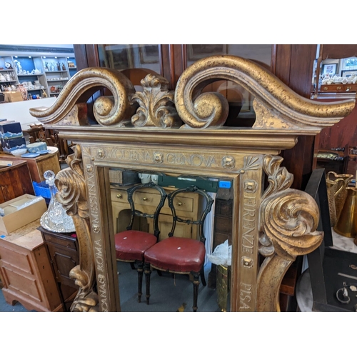 376 - A modern gilt framed composition framed mirror, with scrolled ornament and text 163h x 122w
Location... 