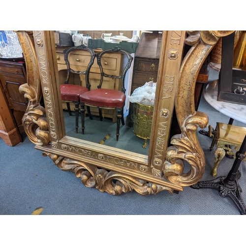 376 - A modern gilt framed composition framed mirror, with scrolled ornament and text 163h x 122w
Location... 