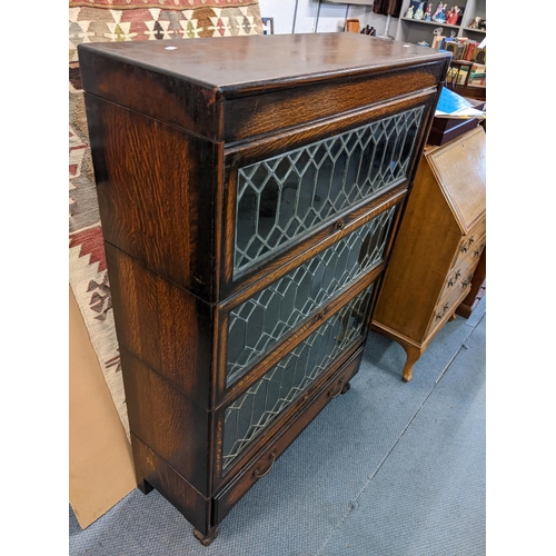 405 - An early 20th century oak three tier Globe Wernicke style bookcase with drawer below, 128h x 87w
Loc... 