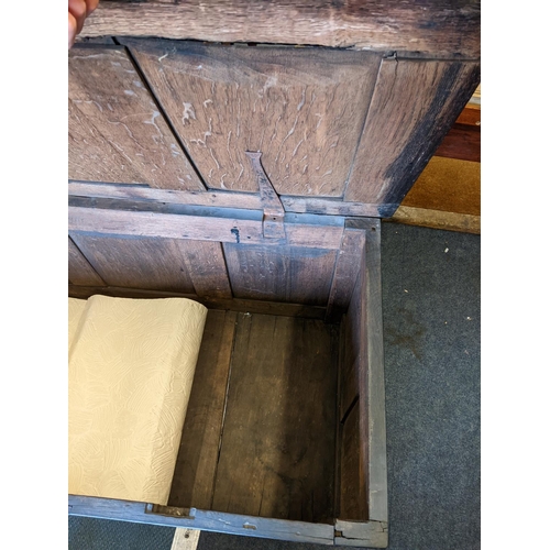 411 - A 18th century oak coffer having a hinged top above four panel front
Location: RAB