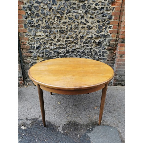 53 - A mid-century teak circular table, together with a set of four G-Plan 'Fresco' black vinyl and teak ... 