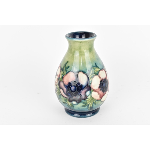 100 - A Walter Moorcroft pottery vase in the 'Anemone' pattern, of baluster form with tube-lined pink/purp... 