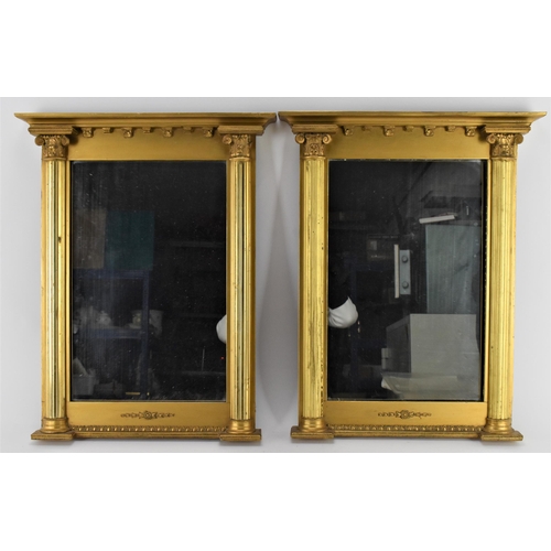 168 - A pair of regency style mirrors, with rectangular plates framed by giltwood flanking reeded columns ... 