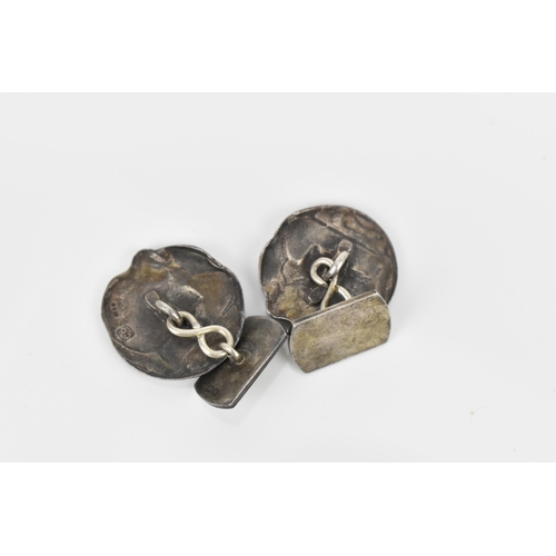 178 - A pair of silver and enamel Art Nouveau style cuff links, of circular form with hammered silver prof... 