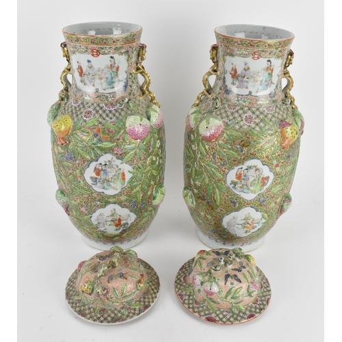 220 - A pair of Chinese Canton Qing dynasty porcelain lidded vases, 19th century, of baluster form, each w... 