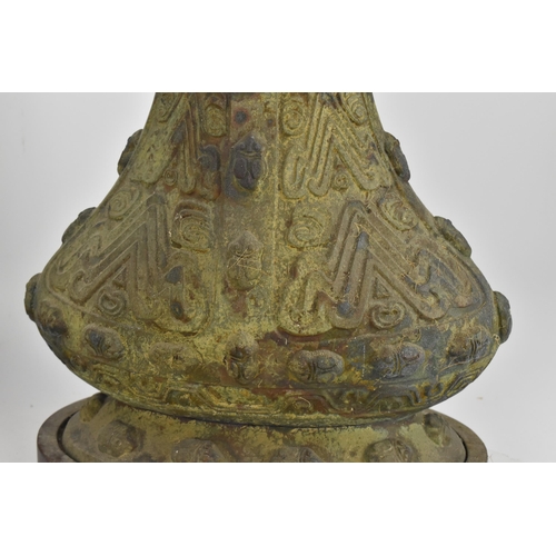 222 - A pair of Chinese heavy bronze lamps in the archaic design, of baluster form supported on wooden bas... 