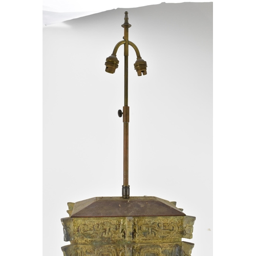 223 - A Chinese heavy bronze lamp in the archaic design, of tapered rectangular form, on a wooden base, wi... 