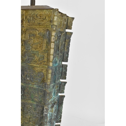 223 - A Chinese heavy bronze lamp in the archaic design, of tapered rectangular form, on a wooden base, wi... 