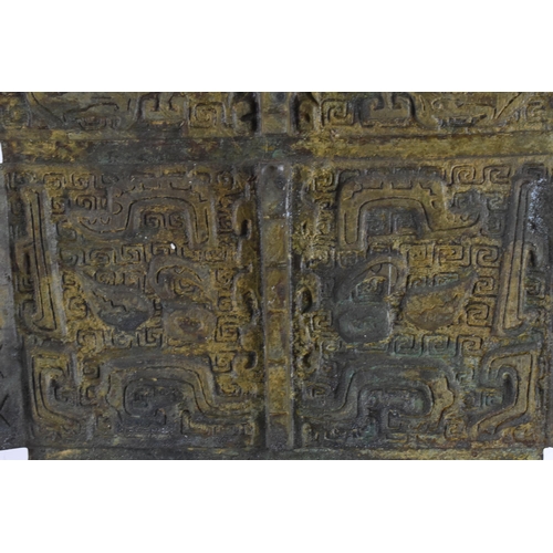 223 - A Chinese heavy bronze lamp in the archaic design, of tapered rectangular form, on a wooden base, wi... 